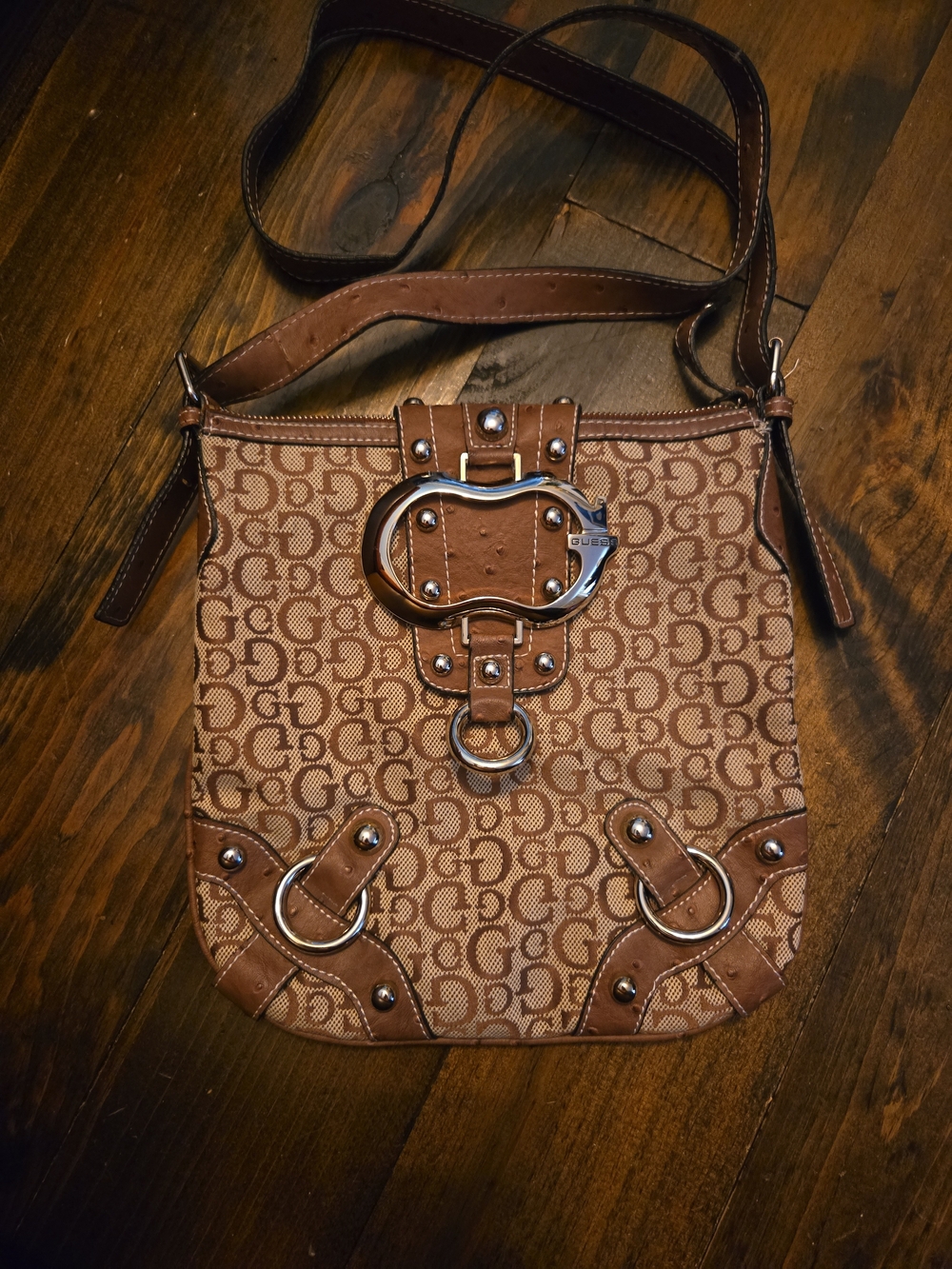 The Guess Vintage Monogram Shoulder Bag in Brown Beige combines a classic monogr